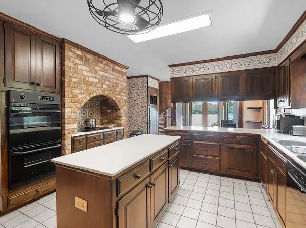 a kitchen with a stove a sink and refrigerator