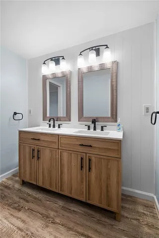 a bathroom with a double vanity sink and a mirror