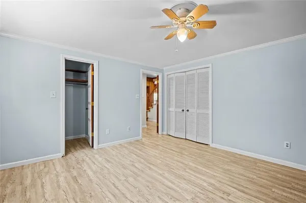 a view of a room with a empty space and a ceiling fan