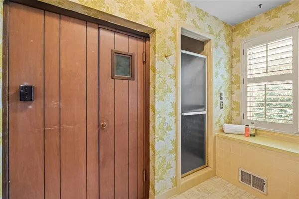 a bathroom with a shower and a tub