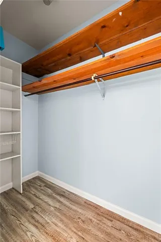 a view of a room with wooden floor