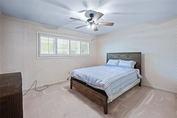 a bedroom with a bed and window