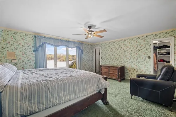 a bedroom with a bed couch and window