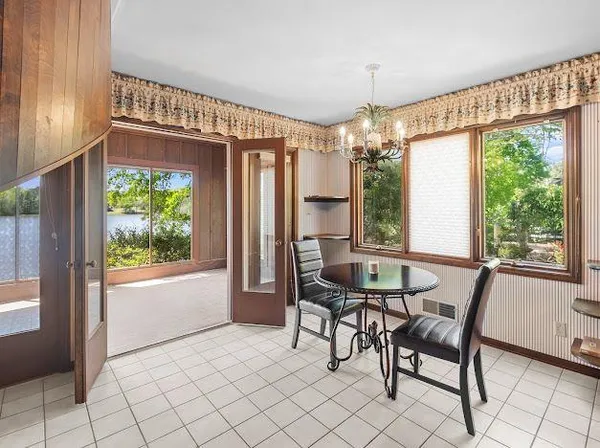 a dining room with furniture and window