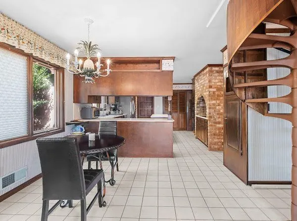 a view of a dining room with furniture and a chandelier