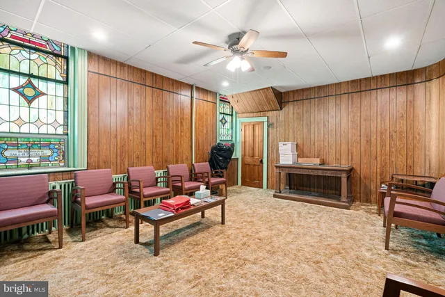 a view of a livingroom with wooden floor and a cabinet