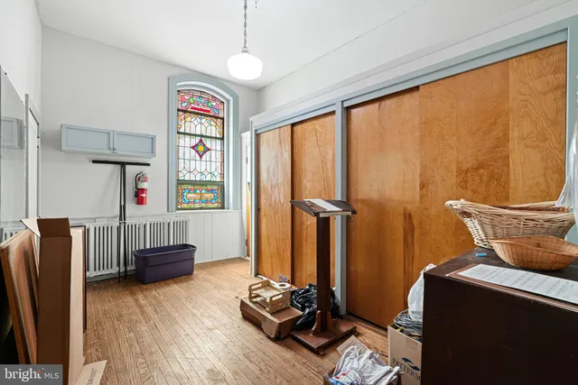 a workspace with wooden floor and a window