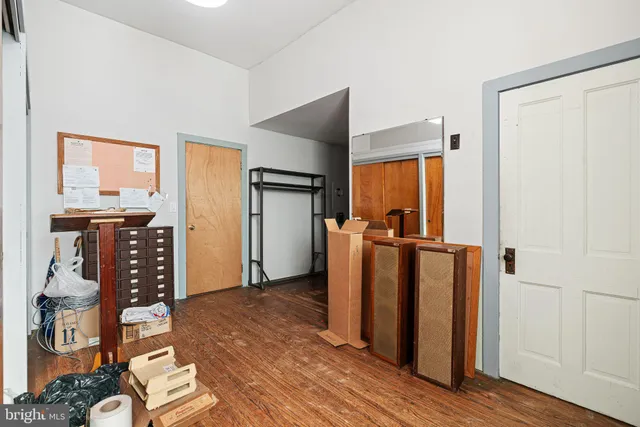 a room with furniture and a kitchen view