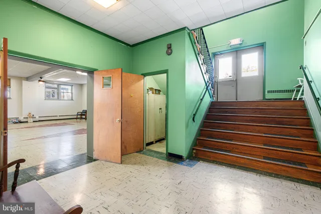 a gym with lots of furniture and a large window