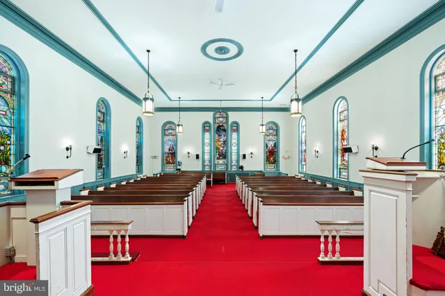 a living room with furniture a rug and white walls