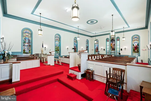 a room with furniture pool table and window