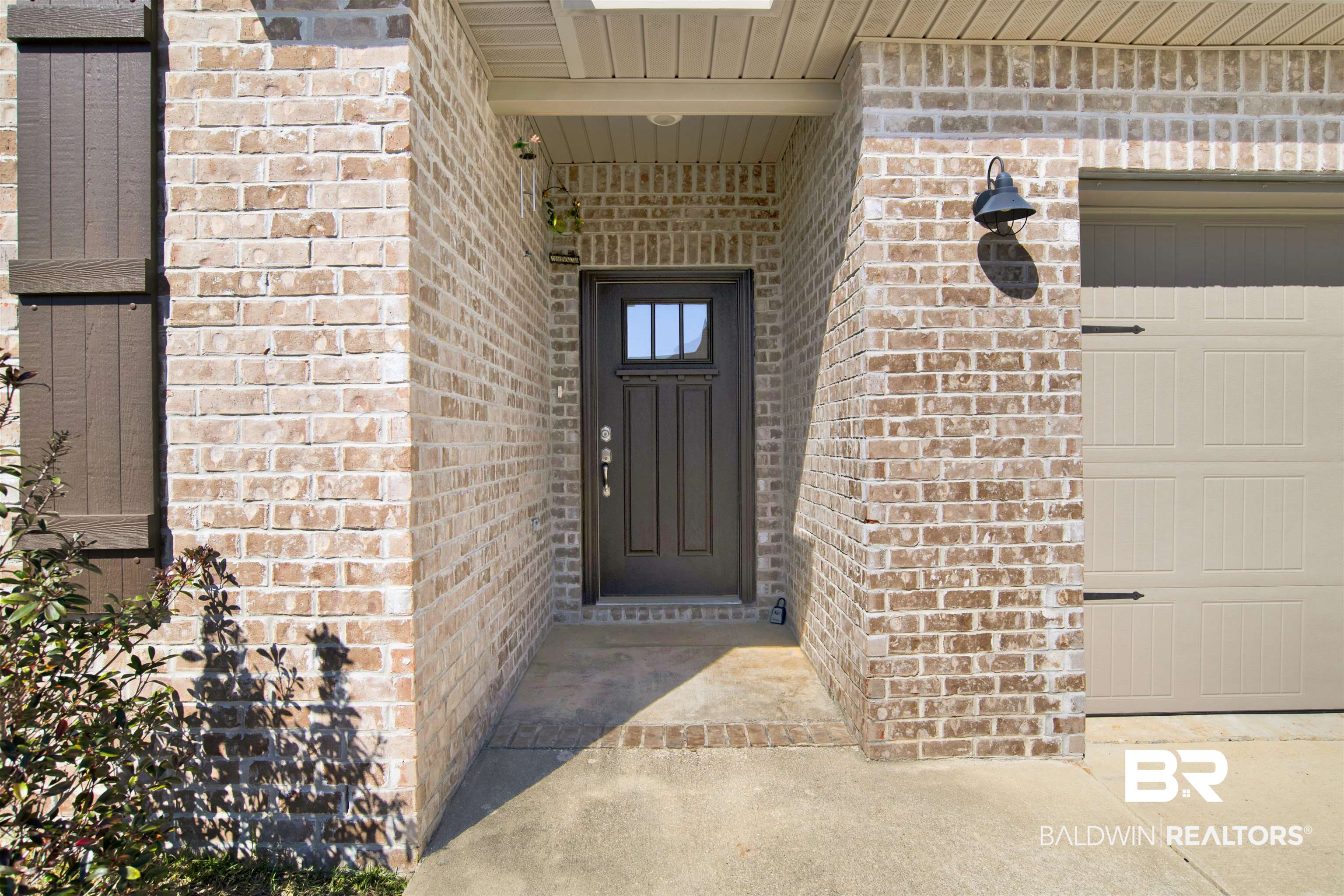 1174 Pheasant Circle Foley, AL 36535 - Photo 4 of 29 View of exterior entry with brick siding and a garage