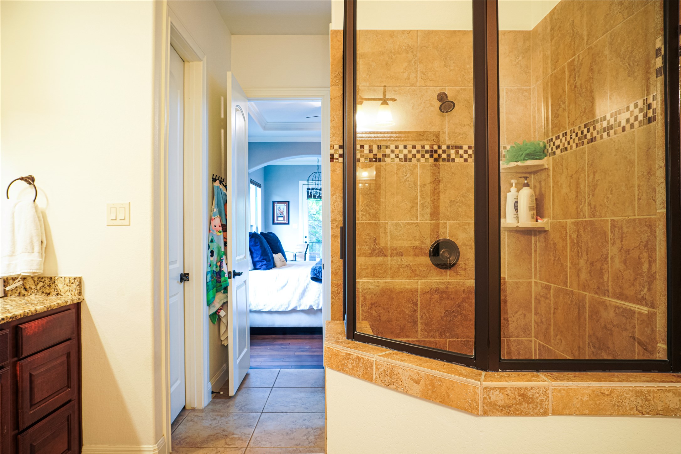 102 Indigo Run Cove Austin, TX 78738 - Photo 12 of 24 Full bath featuring ensuite bathroom, a stall shower, vanity, and light tile patterned floors