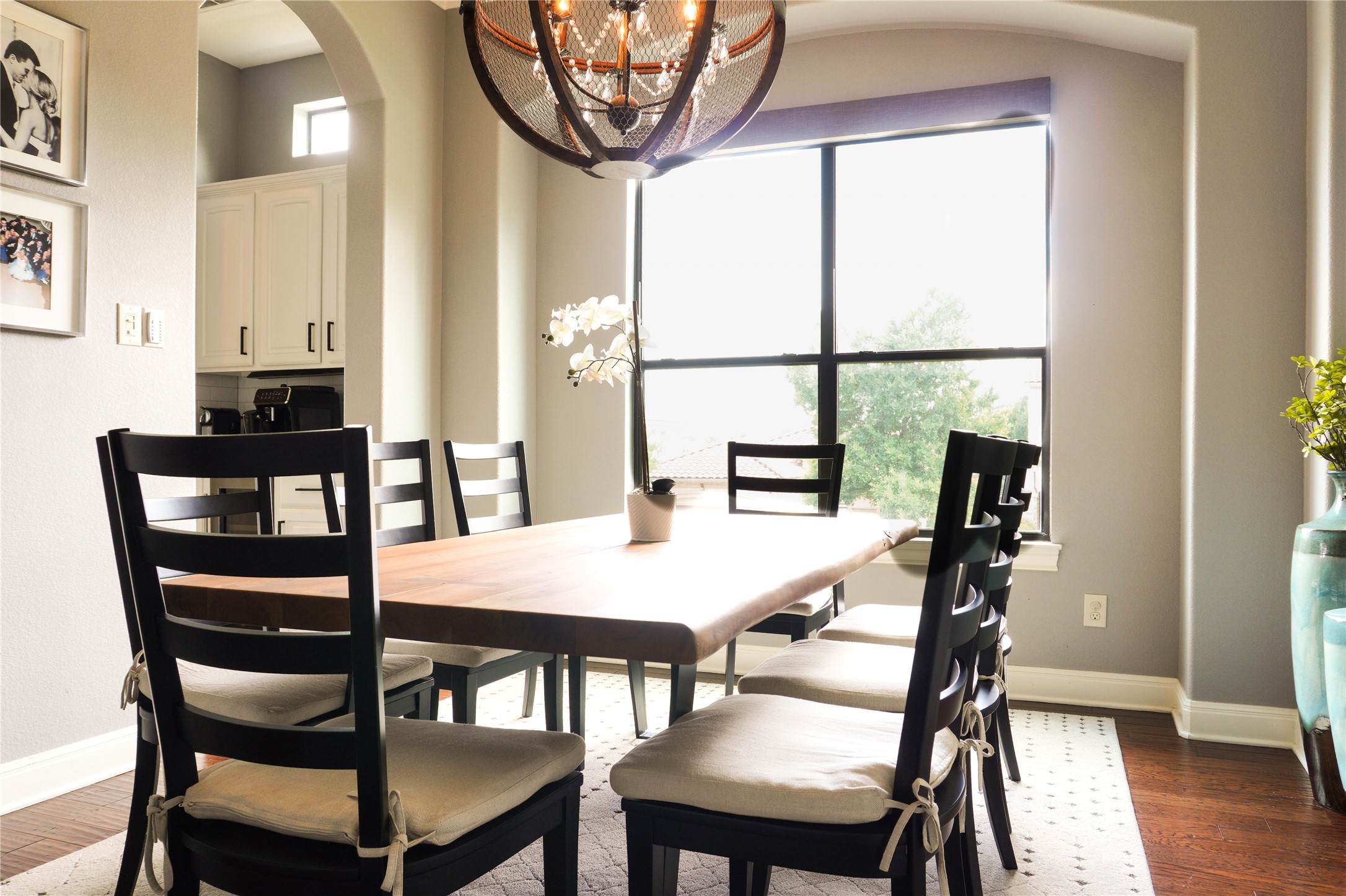 102 Indigo Run Cove Austin, TX 78738 - Photo 6 of 24 Dining area with arched walkways, suspended lighting, and wood finished floors