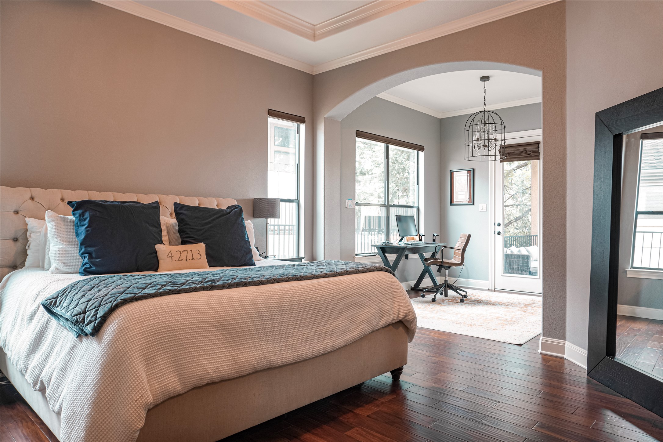102 Indigo Run Cove Austin, TX 78738 - Photo 9 of 24 Bedroom with dark wood-style flooring, ornamental molding, arched walkways, access to exterior, and a chandelier