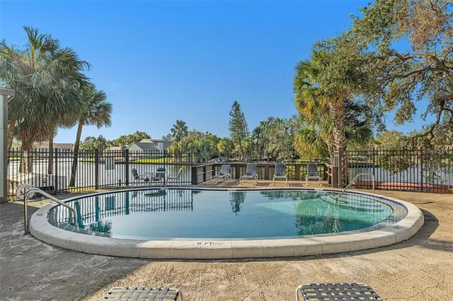 a view of a swimming pool with outdoor seating