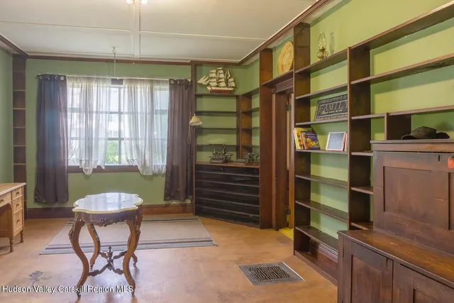 a dining room with stainless steel appliances a dining table and chairs with outer view