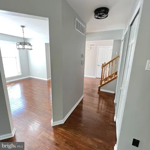 a view of a hallway view with wooden floor and staircase