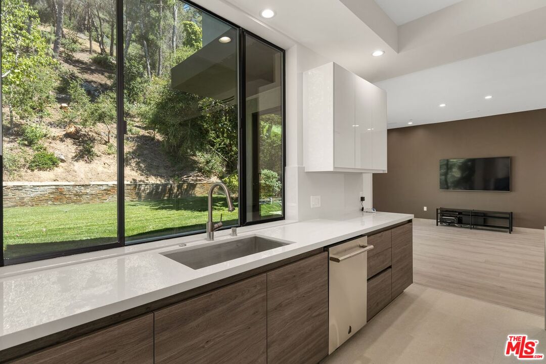9719 Blantyre Drive Beverly Hills, CA 90210 - Photo 16 of 43 a kitchen with a sink and a large window