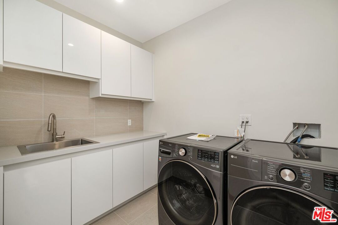 9719 Blantyre Drive Beverly Hills, CA 90210 - Photo 24 of 43 a utility room with sink dryer and washer