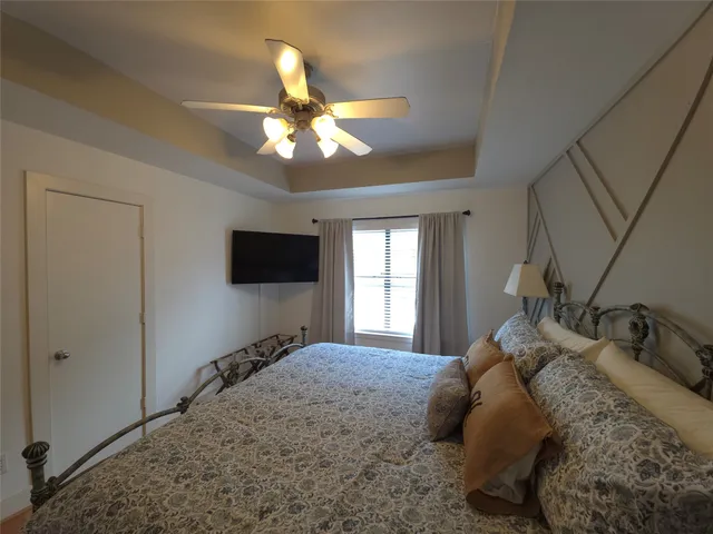 a bedroom with a bed and a flat screen tv