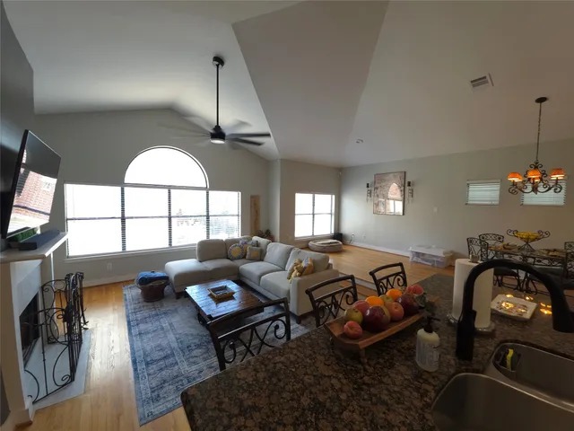 a living room with furniture a chandelier and a window