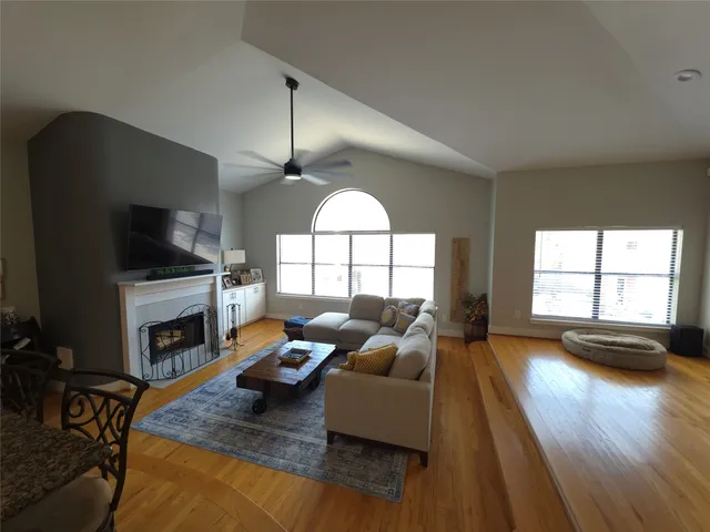 a living room with furniture fireplace and flat screen tv