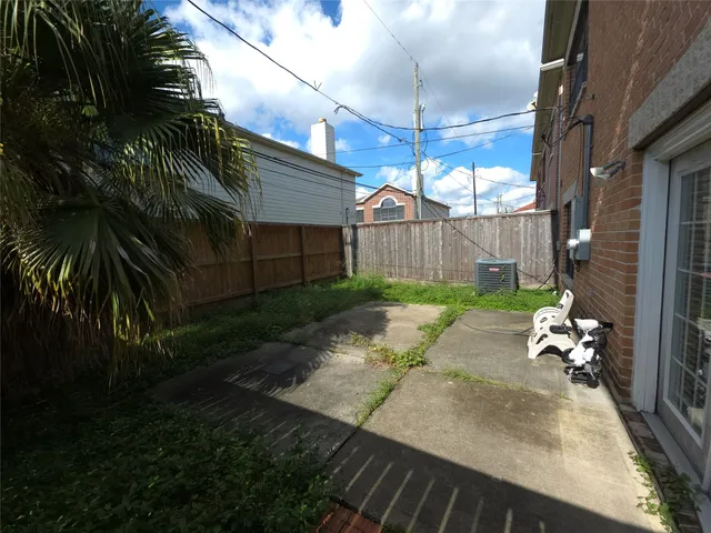 a view of a backyard with plants and a patio