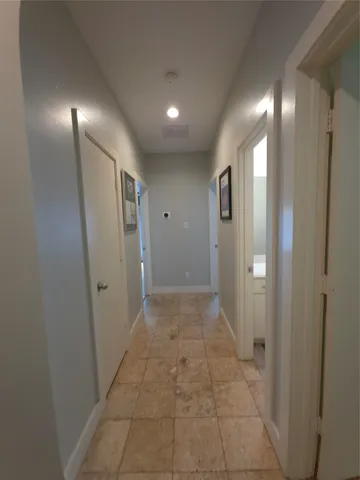 a view of hallway with bathroom