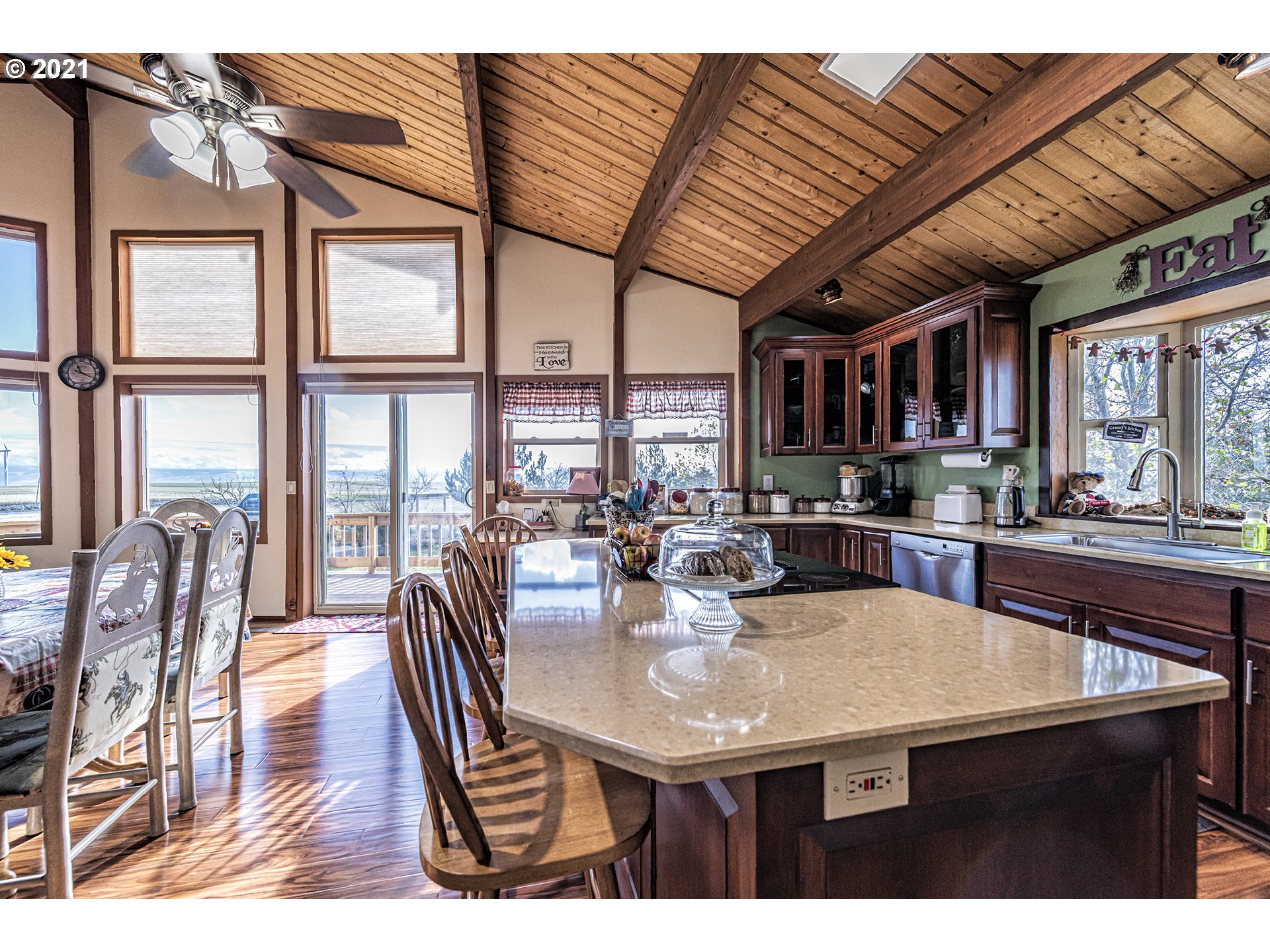 81876 Gerking Flat Road Athena, OR 97813 - Photo 9 of 30 a kitchen with stainless steel appliances granite countertop a table chairs and a wooden floor