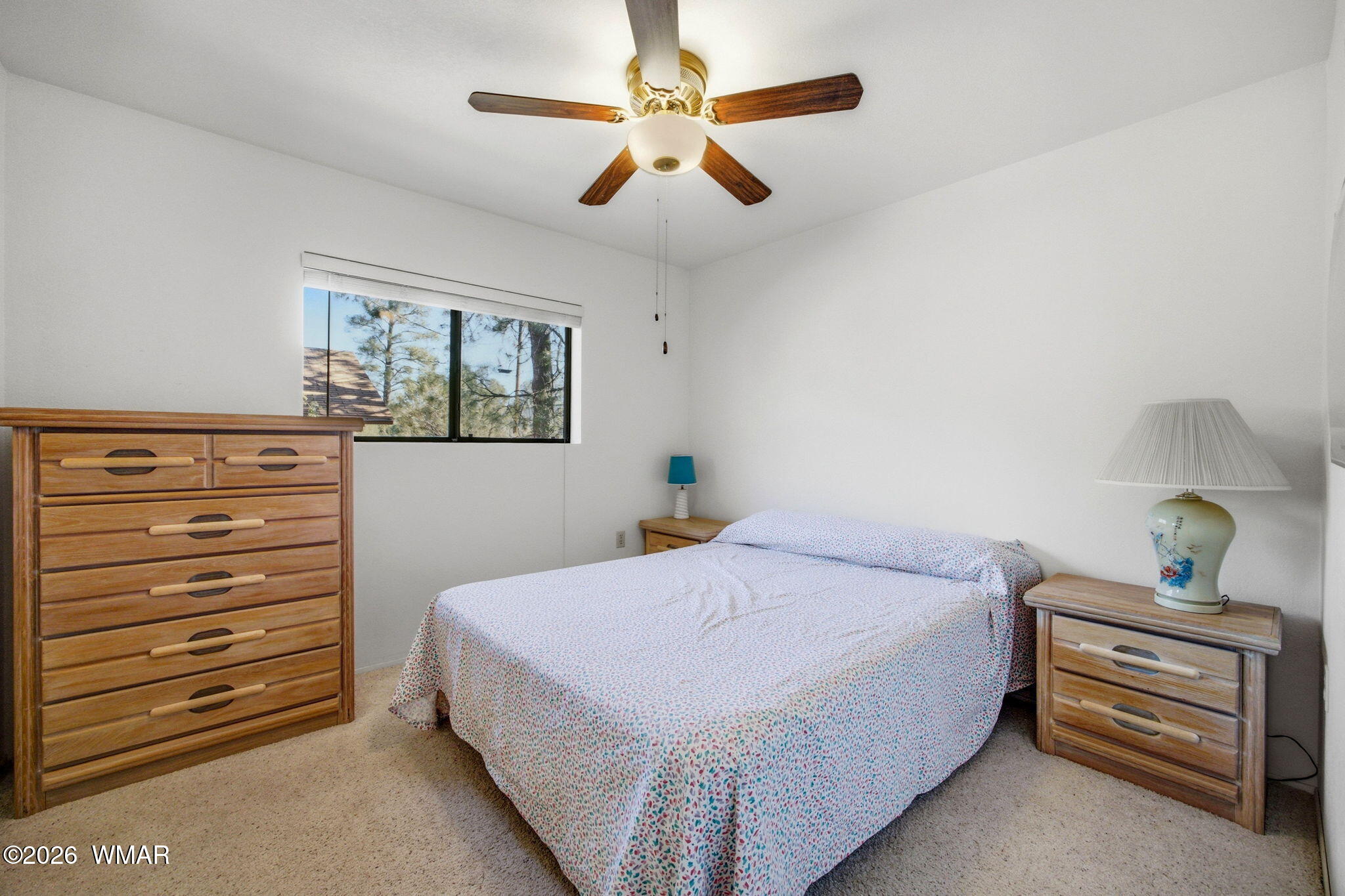 1924 Little Doe Trail Overgaard, AZ 85933 - Photo 14 of 31 a bedroom with a bed and a chandelier