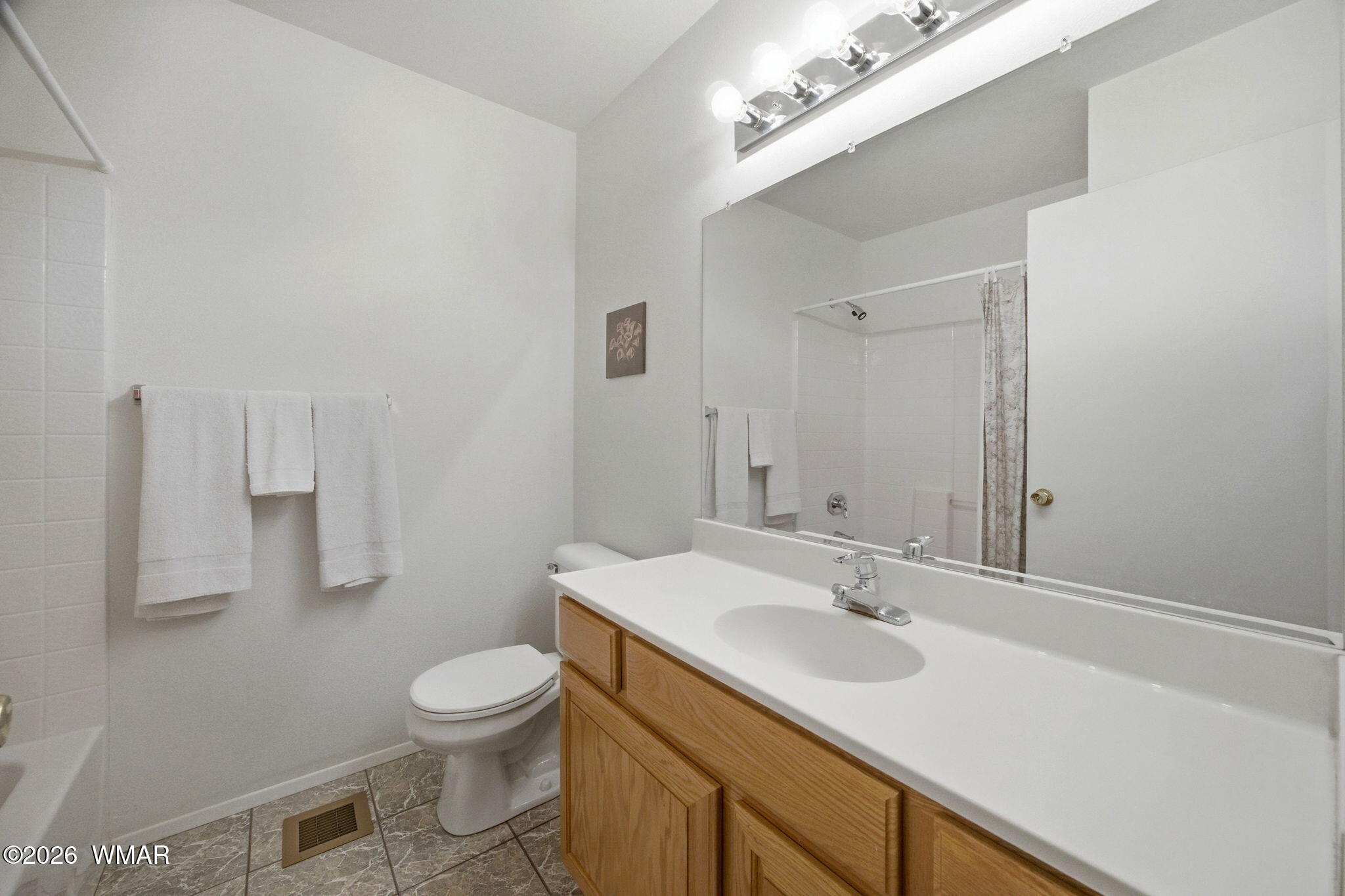 1924 Little Doe Trail Overgaard, AZ 85933 - Photo 16 of 31 a bathroom with a sink a toilet and a mirror