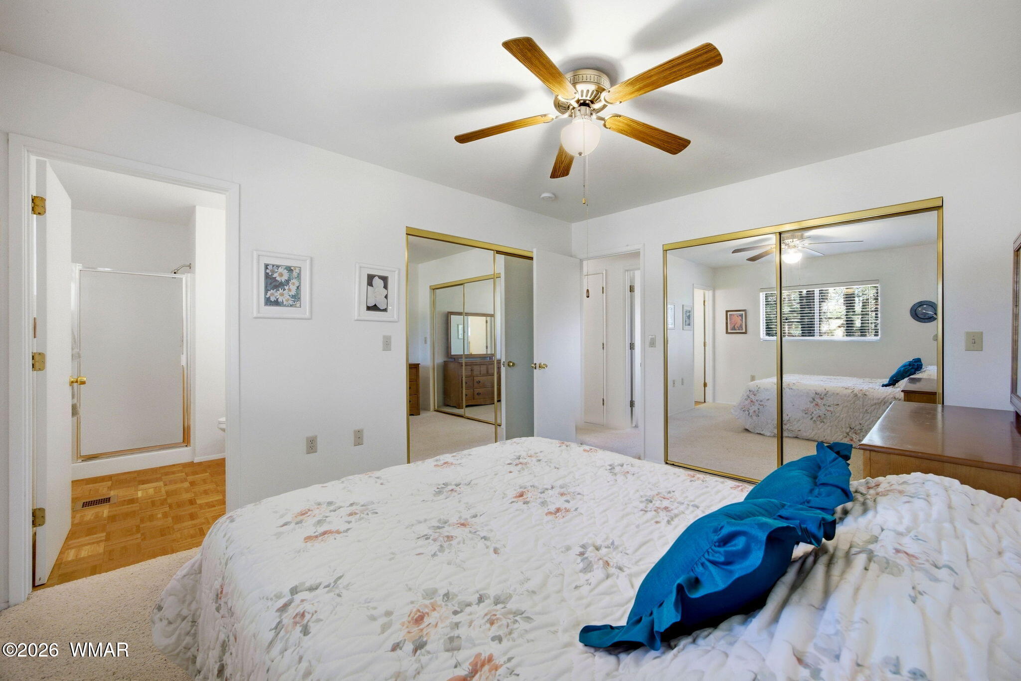 1924 Little Doe Trail Overgaard, AZ 85933 - Photo 19 of 31 a bedroom with a large bed and a chandelier