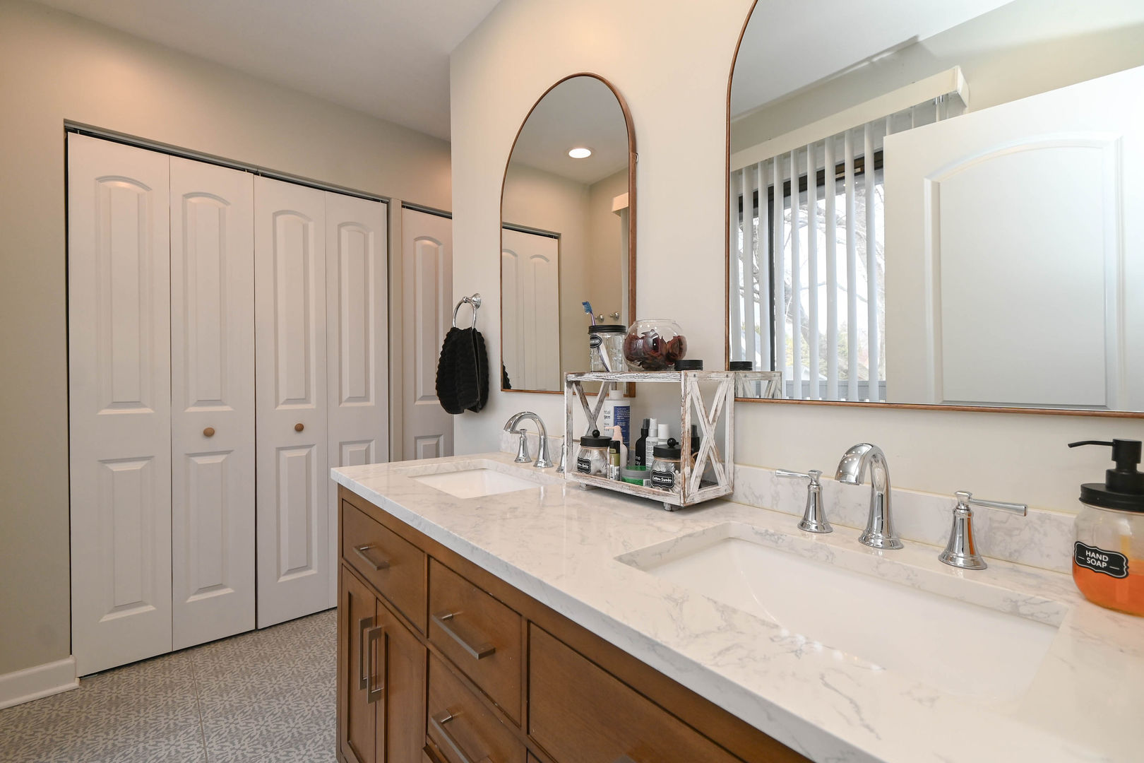 598 Dunham Road Gurnee, IL 60031 - Photo 17 of 31 a bathroom with a double vanity sink and a mirror