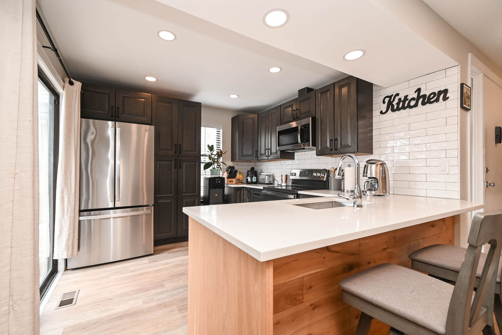 598 Dunham Road Gurnee, IL 60031 - Photo 7 of 31 a kitchen with kitchen island a refrigerator stove a sink and a microwave