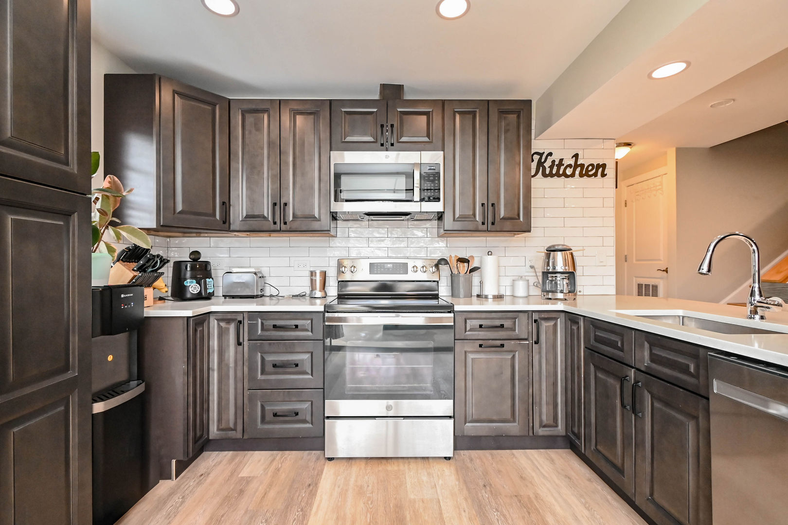 598 Dunham Road Gurnee, IL 60031 - Photo 9 of 31 a kitchen with stainless steel appliances granite countertop a stove top oven a sink dishwasher and cabinets with wooden floor