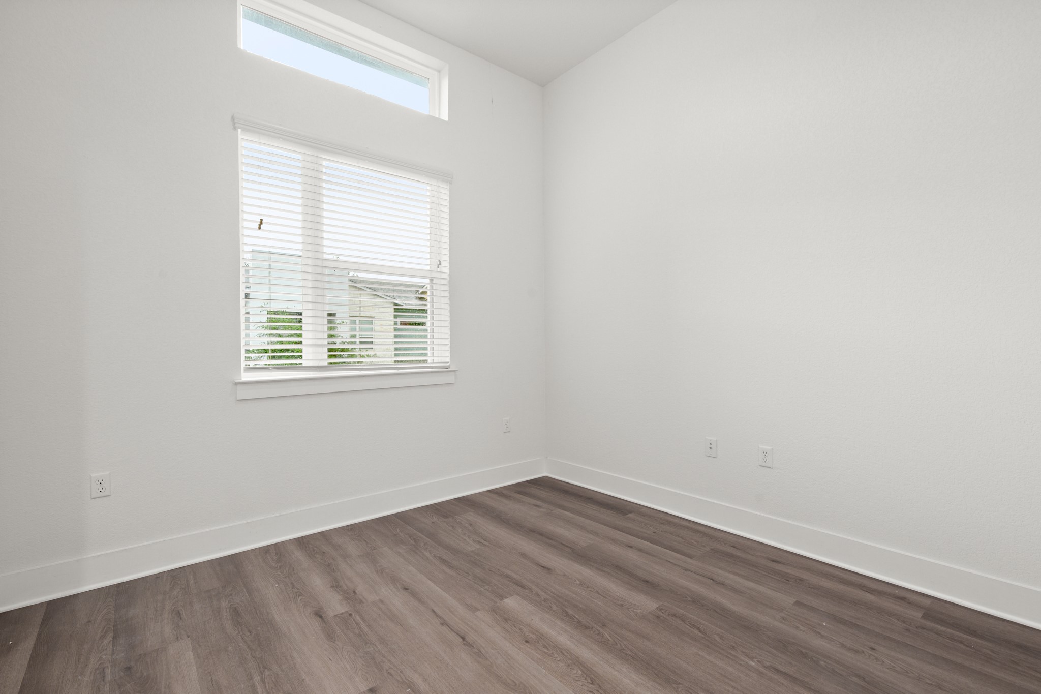 8922 Manchaca Road, Unit 701 Austin, TX 78748 - Photo 16 of 25 an empty room with wooden floor and windows