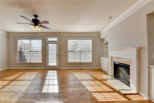 a view of a livingroom with a fireplace and windows