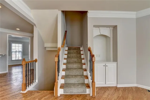 a view of entryway and hall with wooden floor