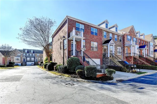 a front view of a building with cars parked