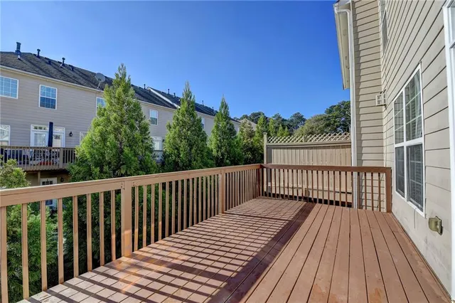 a balcony with wooden floor and fence