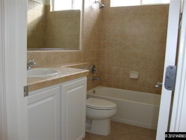 14020 Tagor Road Reno, NV 89521 - Photo 6 of 9 a bathroom with a sink a toilet and shower