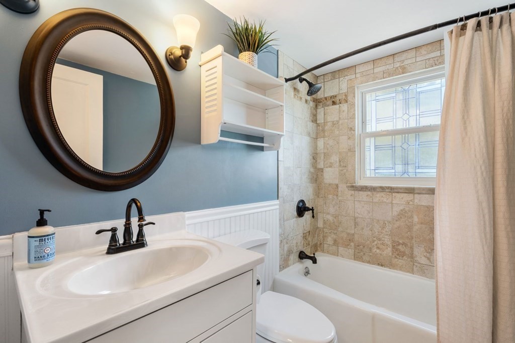 33 Bromfield Street, Unit 33 Watertown, MA 02472 - Photo 11 of 21 a bathroom with a sink a toilet and a mirror