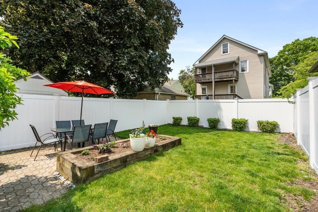 33 Bromfield Street, Unit 33 Watertown, MA 02472 - Photo 16 of 21 a backyard of a house with table and chairs