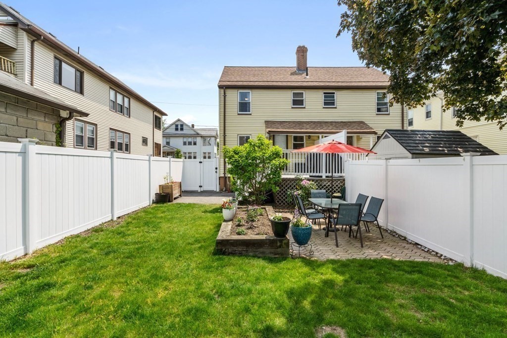 33 Bromfield Street, Unit 33 Watertown, MA 02472 - Photo 17 of 21 a view of backyard with a table and chairs and potted plants