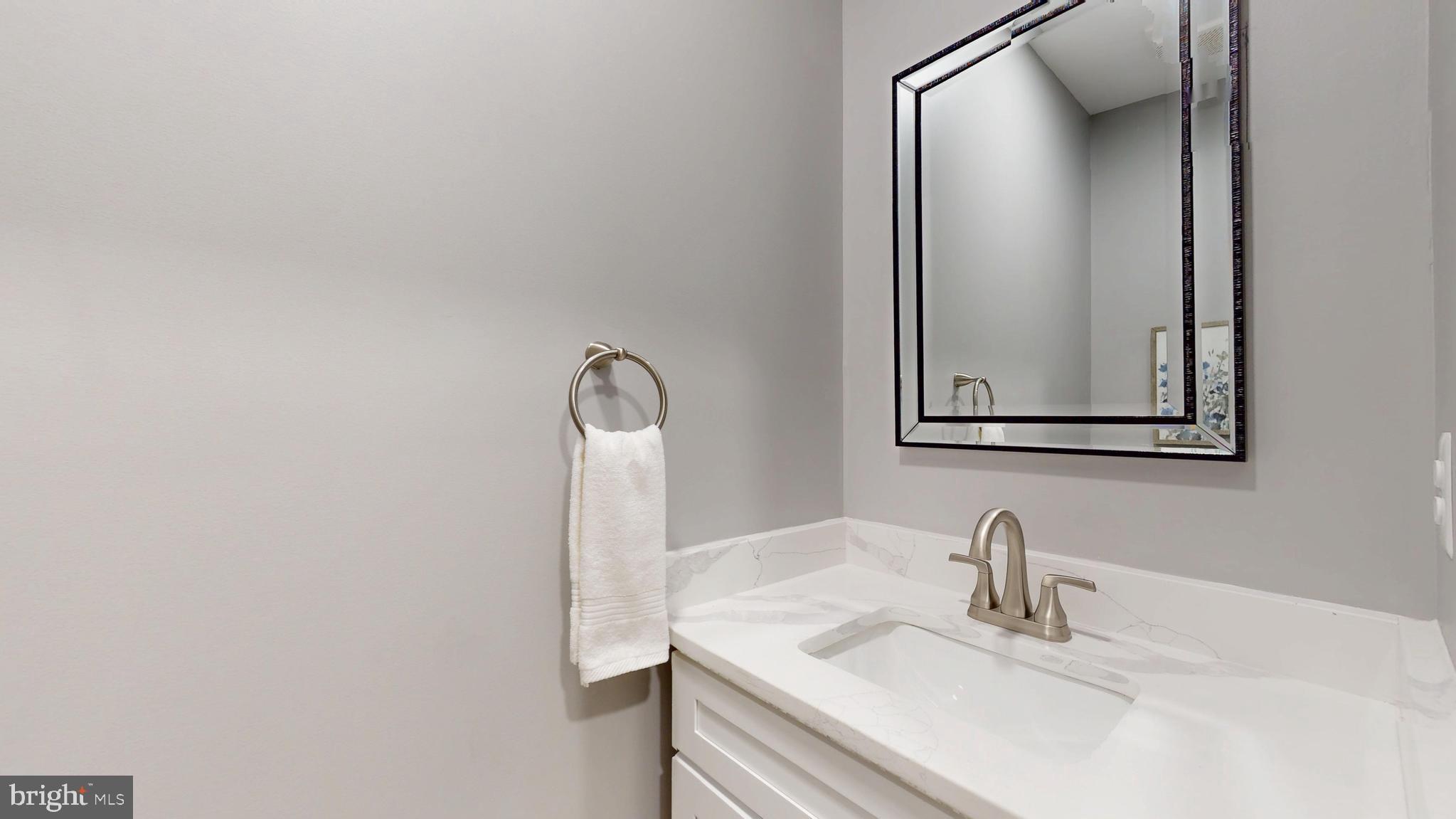 2519 East Fairmount Avenue Baltimore, MD 21224 - Photo 13 of 25 a bathroom with a sink and a mirror