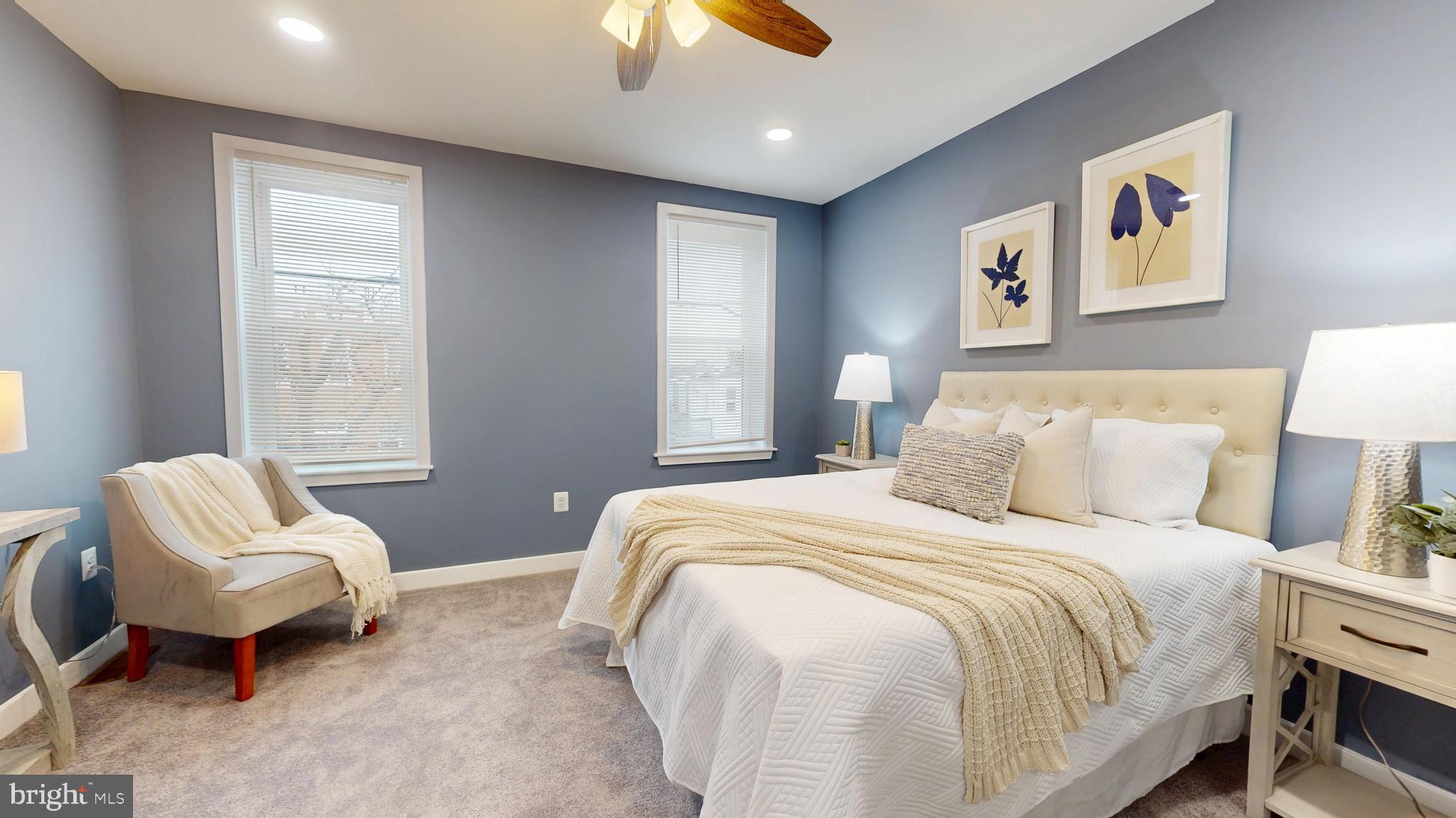 2519 East Fairmount Avenue Baltimore, MD 21224 - Photo 15 of 25 a bedroom with a bed and a chandelier