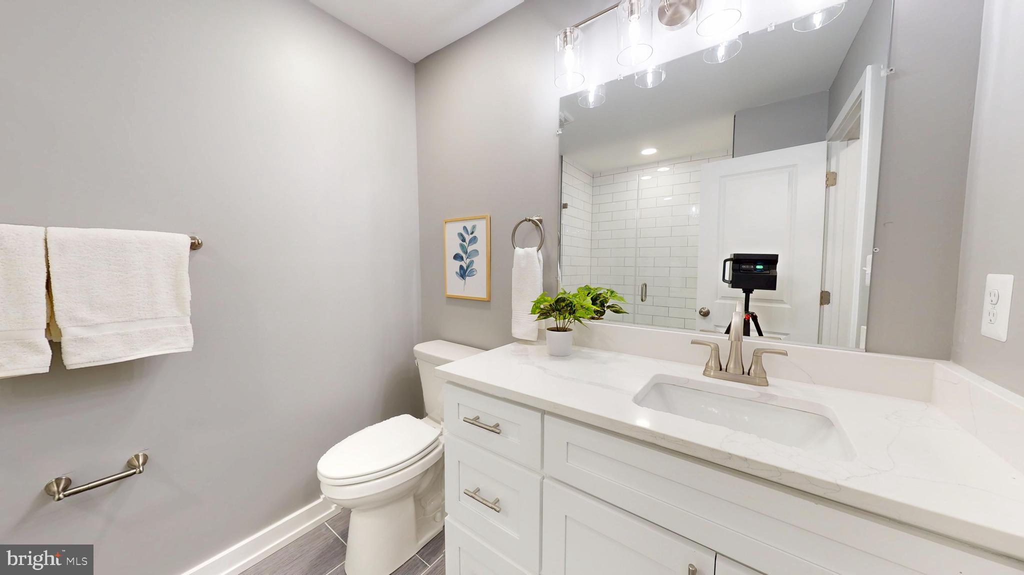2519 East Fairmount Avenue Baltimore, MD 21224 - Photo 16 of 25 a bathroom with a sink a toilet and mirror