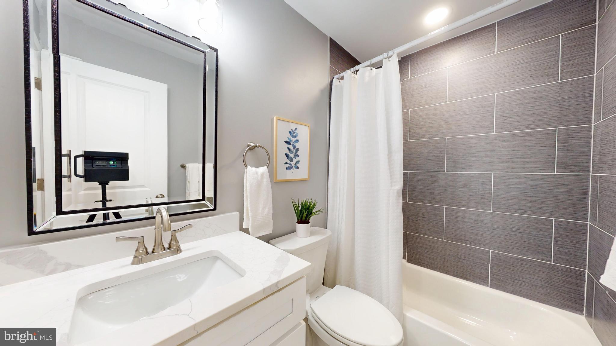 2519 East Fairmount Avenue Baltimore, MD 21224 - Photo 20 of 25 a bathroom with a sink toilet and shower