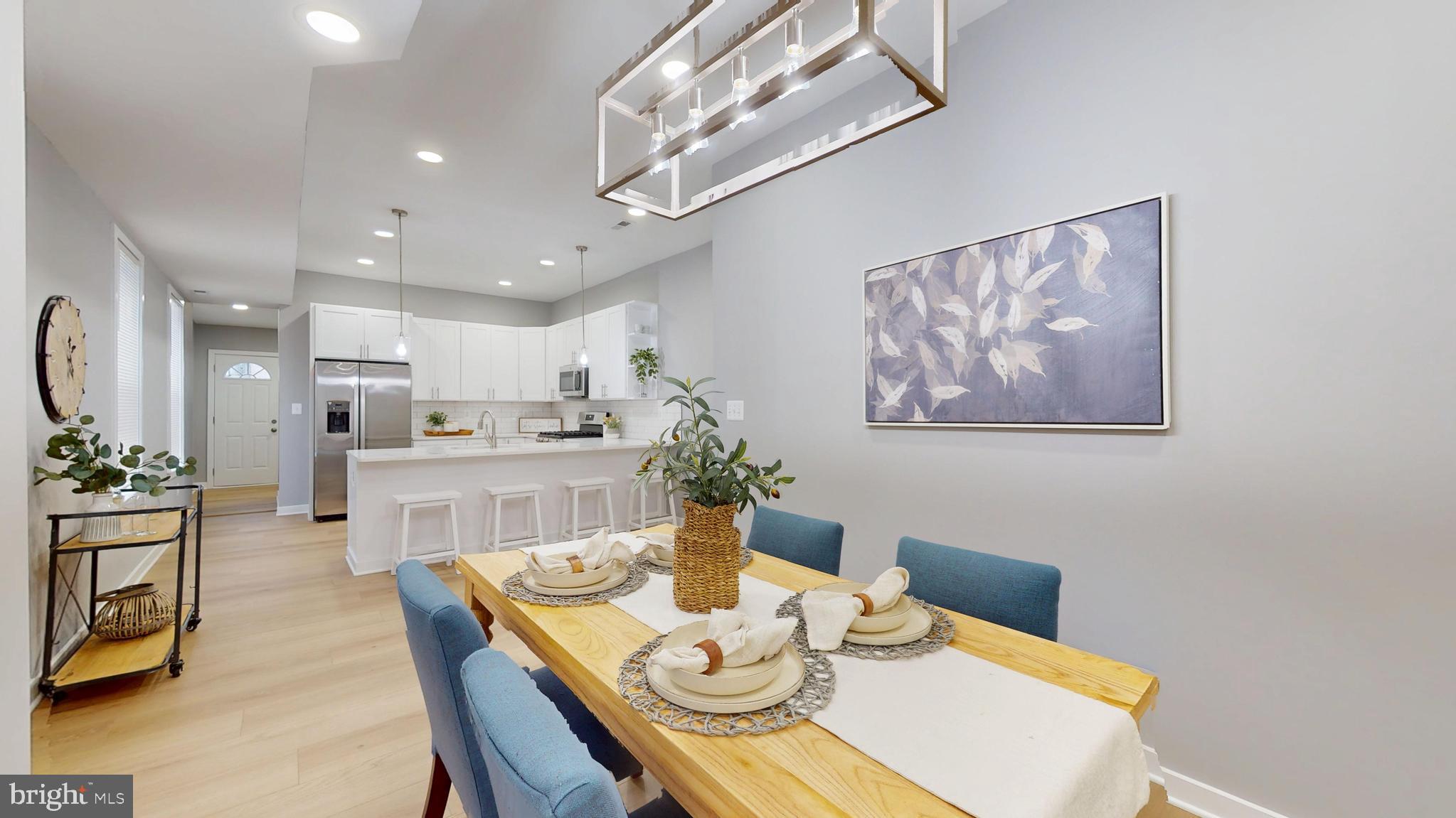 2519 East Fairmount Avenue Baltimore, MD 21224 - Photo 6 of 25 a view of a dining room with furniture a chandelier and wooden floor